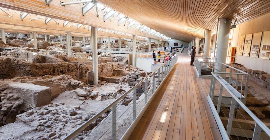 Archaeological Bus Tour To Akrotiri Excavations & Red Beach - The bus, pickup points, and pace