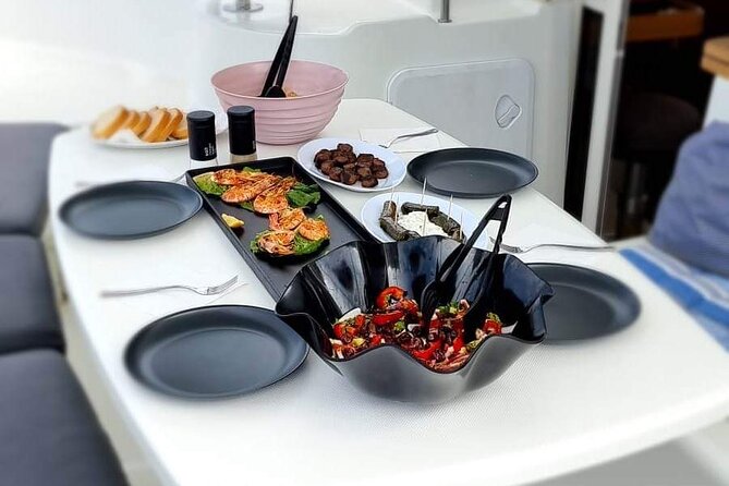 Catamaran Day & Sunset Cruises with meals Drinks and transportation - Passing Baos and Delos from the catamaran