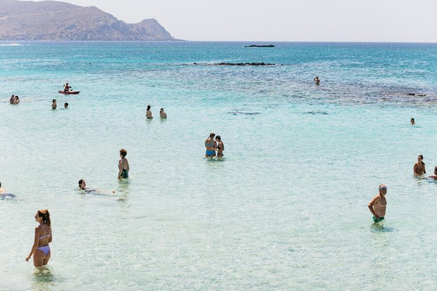 Wading out through the shallows to the pink sand at Elafonisi, west Crete