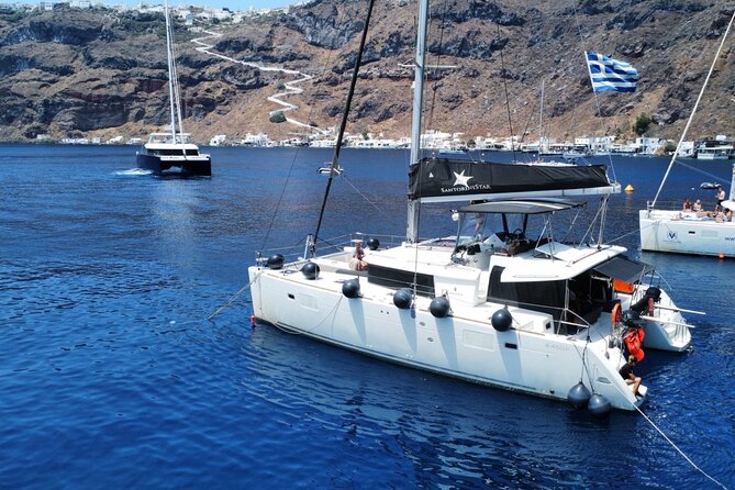 Half Day Premium Catamaran Cruise in Santorini including Oia - Red Beach begins the coastal tour