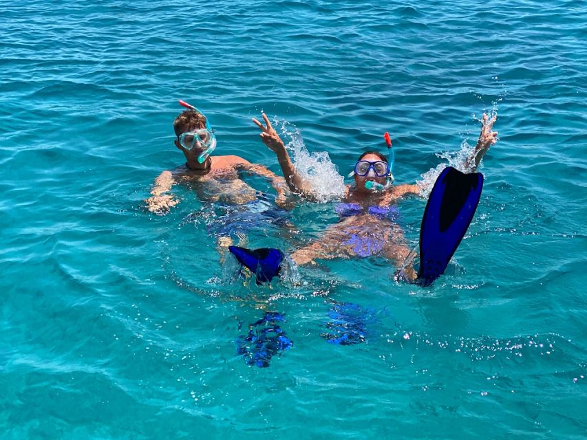 Hersonissos: Sunset Catamaran Cruise with Snacks and Drinks - Agios Georgios Bay and the water activities