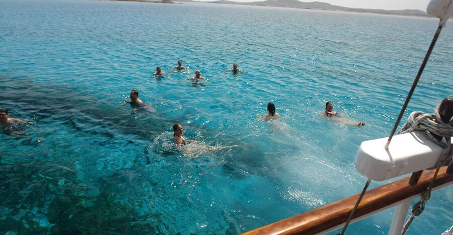 Mykonos: Sunset Party Boat Cruise with 1 Drink - Leaving the Old Port on a traditional wooden boat