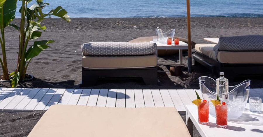 Perivolos Beach: Sun-Bed Experience FortyOne Bar Restaurant - Perivolos water and the black lava shore