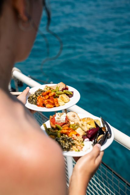 Rhodes: Bay to Bay Swim Cruise with Greek Buffet and Wine - Music, decks, and the trip back to Mandraki