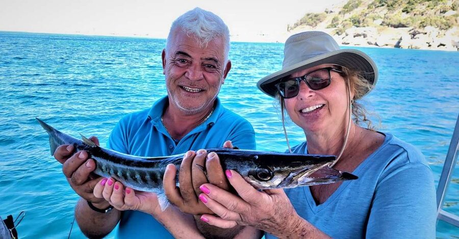 Rhodes: Fishing Trip, Snorkelling, BBQ, & Professional Guide - Swimming and snorkeling in a quiet bay