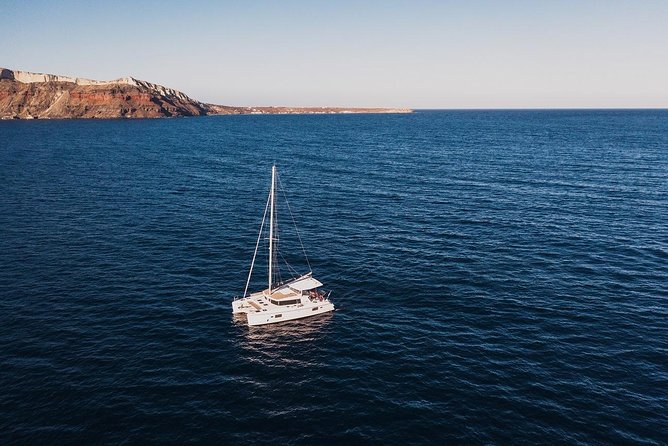 Romantic Sunset Catamaran Caldera Cruise incl. Meal & Drinks - Sunset near Oia and Ammoudi Bay