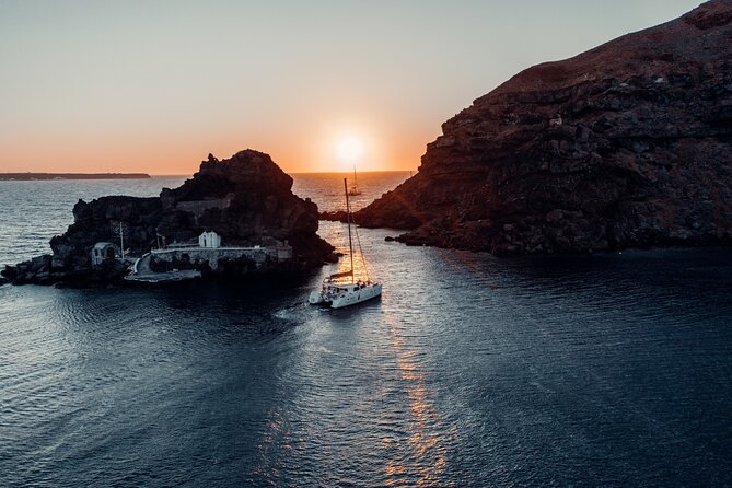 Romantic Sunset Catamaran Caldera Cruise incl. Meal & Drinks - Red Beach and the first look at the volcanic coast