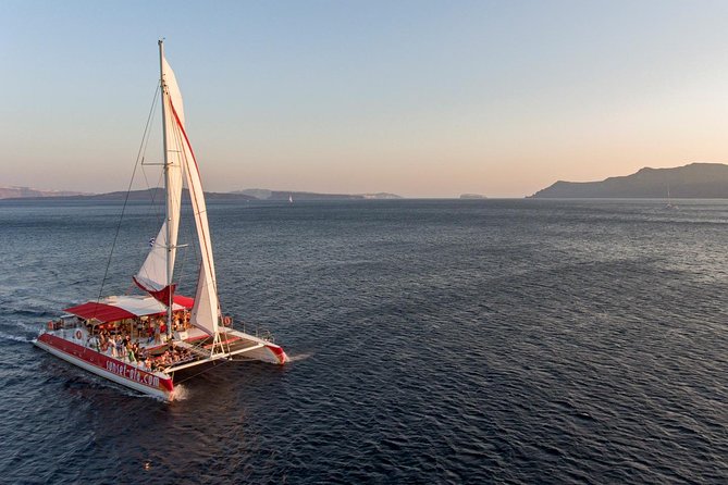 Sailing Catamaran Cruise in Santorini with BBQ, Drinks and Transfer - Red Beach from the sea