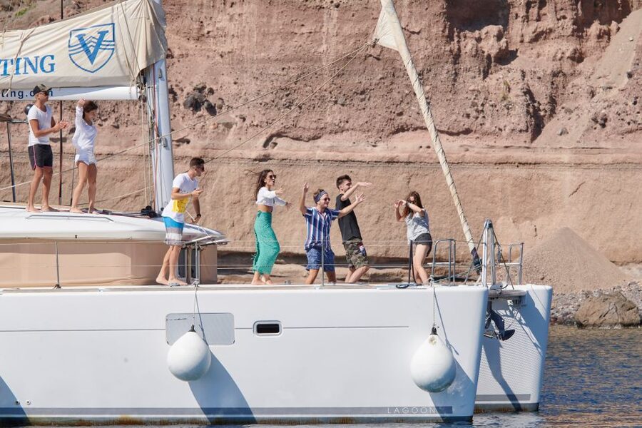 Santorini Gold Catamaran Cruise with Snorkel, BBQ & Open Bar - White Beach and the Venetian lighthouse from offshore
