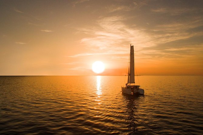 Santorini Luxury Catamaran Sunset Cruise with BBQ, Drink and Transfer - Red Beach from the water