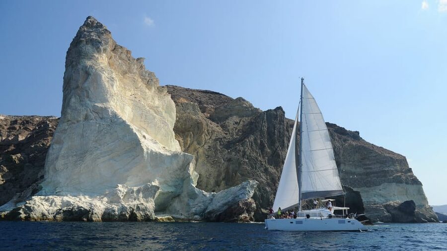Santorini: Private Catamaran Tour with BBQ Meal and Drinks - A final swim and the view toward Thirasia